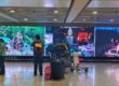 Upgraded LED screen installation at Bali International Airport arrival area in 2025 by The Perfect Media, displaying vibrant tourism visuals for high-impact digital advertising.