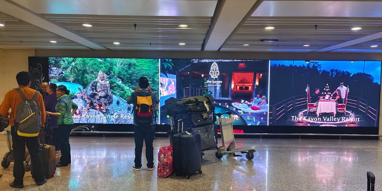 Upgraded LED screen installation at Bali International Airport arrival area in 2025 by The Perfect Media, displaying vibrant tourism visuals for high-impact digital advertising.