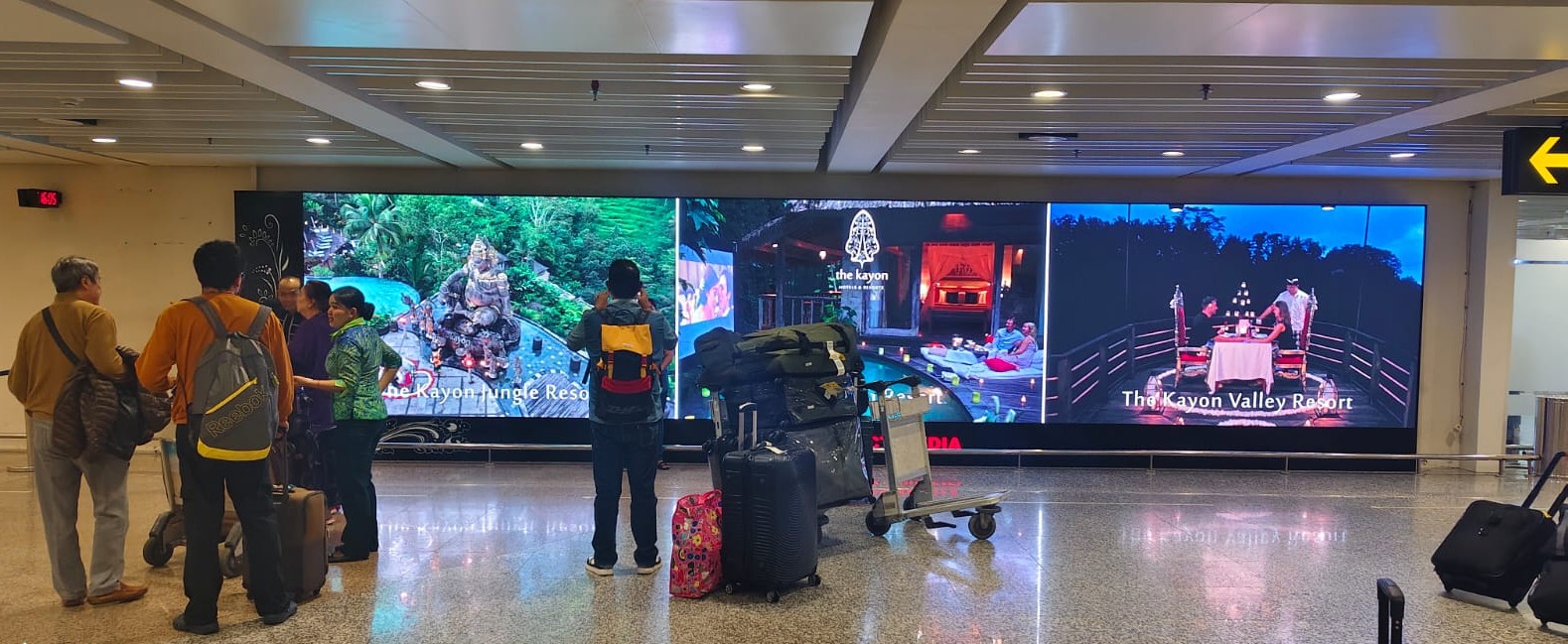 Upgraded LED screen installation at Bali International Airport arrival area in 2025 by The Perfect Media, displaying vibrant tourism visuals for high-impact digital advertising.